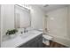 A bathroom with a modern vanity, sink, and fixtures, complemented by a shower-tub combination at 724 Eastwood Rise, Stone Mountain, GA 30087