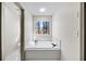 Bathroom featuring a soaking tub and large window at 724 Eastwood Rise, Stone Mountain, GA 30087