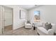 Bedroom featuring new carpet, a large window, and seating area at 724 Eastwood Rise, Stone Mountain, GA 30087