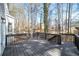 A spacious wooden deck surrounded by trees, offering a relaxing outdoor space at 724 Eastwood Rise, Stone Mountain, GA 30087