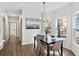 Dining area with a dark wood table, chandelier, and a large window overlooking a treed yard at 724 Eastwood Rise, Stone Mountain, GA 30087