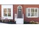 Close up on the front entrance, showcasing the door, white trim, and well-maintained landscaping at 724 Eastwood Rise, Stone Mountain, GA 30087