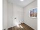 Bright laundry room with hardwood floors, a window, and utility connections at 724 Eastwood Rise, Stone Mountain, GA 30087