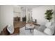 Open living room with neutral decor, wood floors, and a view into the dining room at 724 Eastwood Rise, Stone Mountain, GA 30087