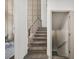 Carpeted staircase with a decorative wall and access to the basement at 724 Eastwood Rise, Stone Mountain, GA 30087