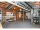 Unfinished basement area with workbench, storage shelves, exposed pipes and mechanicals at 870 Richmond Hill Dr, Marietta, GA 30068