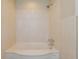 Bathroom tub with white marble surround and shower head at 870 Richmond Hill Dr, Marietta, GA 30068