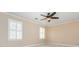 Bedroom featuring ceiling fan and bright windows with plantation shutters at 870 Richmond Hill Dr, Marietta, GA 30068