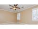 Bedroom featuring neutral walls, ceiling fan, and shuttered windows at 870 Richmond Hill Dr, Marietta, GA 30068