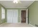 Green bedroom with closet, ceiling fan, and entry to hallway at 870 Richmond Hill Dr, Marietta, GA 30068