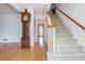 Elegant foyer showcasing hardwood floors, staircase, and a classic grandfather clock at 870 Richmond Hill Dr, Marietta, GA 30068