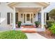 Inviting front porch featuring brick steps, a decorative door, and manicured landscaping at 870 Richmond Hill Dr, Marietta, GA 30068