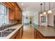 A kitchen featuring wood cabinets, stainless steel appliances and island, and access to a dining space at 870 Richmond Hill Dr, Marietta, GA 30068