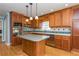 Well-equipped kitchen featuring wood cabinets, modern stainless steel appliances, and hardwood floors at 870 Richmond Hill Dr, Marietta, GA 30068