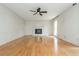 Spacious living room with hardwood flooring, brick fireplace, and modern ceiling fan at 870 Richmond Hill Dr, Marietta, GA 30068