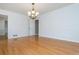 Bright, empty living room exhibiting hardwood floors and vintage chandelier, great for entertaining at 870 Richmond Hill Dr, Marietta, GA 30068