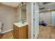 Cozy bathroom featuring wood floors and vanity, next to a bedroom at 1103 Wallington Nw Ct, Conyers, GA 30012