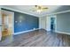 This bedroom offers wood floors, a ceiling fan and a neutral color scheme, with ensuite bathroom access at 1103 Wallington Nw Ct, Conyers, GA 30012