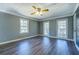 This bedroom features wood-look floors, three windows that let in plenty of natural light, and neutral paint at 1103 Wallington Nw Ct, Conyers, GA 30012