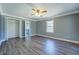 Spacious bedroom with ample closet space, a ceiling fan, and an adjoining bathroom at 1103 Wallington Nw Ct, Conyers, GA 30012