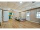 Bedroom has laminate flooring, windows and door with backyard access and a glimpse of the kitchenette at 1103 Wallington Nw Ct, Conyers, GA 30012