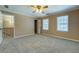 Bedroom showcases neutral walls, plush carpet, and ample natural light at 1103 Wallington Nw Ct, Conyers, GA 30012
