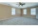 Spacious bedroom features neutral carpet and a ceiling fan at 1103 Wallington Nw Ct, Conyers, GA 30012