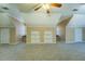 Bonus room with built in storage, neutral walls and plush carpeting at 1103 Wallington Nw Ct, Conyers, GA 30012