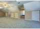 Bonus room showcases a ceiling fan, neutral carpet and lots of storage at 1103 Wallington Nw Ct, Conyers, GA 30012