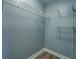 A closet features wire shelving, neutral paint, and wood look floors at 1103 Wallington Nw Ct, Conyers, GA 30012