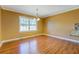 This dining room has hardwood floors and a large window at 1103 Wallington Nw Ct, Conyers, GA 30012