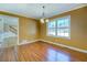 Dining room with hardwood floors, large window offering natural light, and staircase leading to next level at 1103 Wallington Nw Ct, Conyers, GA 30012