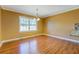 Bright dining area with hardwood floors, ample natural light, with a breakfast bar leading into kitchen at 1103 Wallington Nw Ct, Conyers, GA 30012