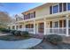Charming front porch with white railings and a beautifully crafted wooden door at 1103 Wallington Nw Ct, Conyers, GA 30012