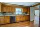 Well-lit kitchen featuring wood cabinets, stainless steel appliances, hardwood floors, and a window at 1103 Wallington Nw Ct, Conyers, GA 30012