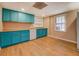Efficient kitchenette has cabinetry, a window, and modern appliances, all with laminate floors at 1103 Wallington Nw Ct, Conyers, GA 30012