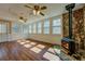 Bright living room featuring hardwood floors, stone fireplace, and multiple windows at 1103 Wallington Nw Ct, Conyers, GA 30012