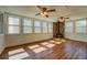 Bright living room featuring hardwood floors, stone fireplace, and multiple windows at 1103 Wallington Nw Ct, Conyers, GA 30012