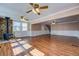 Spacious room featuring hardwood floors and stone fireplace with an adjacent staircase at 1103 Wallington Nw Ct, Conyers, GA 30012