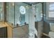 The glass shower features marble-look tile with a shower head and hand wand at 1103 Wallington Nw Ct, Conyers, GA 30012