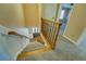 Carpeted staircase with wooden railings leading to the lower level of the home at 1103 Wallington Nw Ct, Conyers, GA 30012