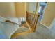 Carpeted stairway features wood railing, leading to the main level at 1103 Wallington Nw Ct, Conyers, GA 30012