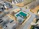 Aerial view of the neighborhood pool, playground, parking lot, and surrounding landscape at 113 Plumeria St, Canton, GA 30114