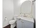 Stylish half-bathroom featuring a modern vanity, arch mirror and neutral decor at 113 Plumeria St, Canton, GA 30114