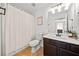Bathroom featuring shower, vanity, and framed artwork at 113 Plumeria St, Canton, GA 30114