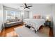 Bright bedroom with hardwood floors, ceiling fan, sofa, and large windows at 113 Plumeria St, Canton, GA 30114