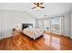 Bright bedroom with hardwood floors, ample natural light, and contemporary furnishings at 113 Plumeria St, Canton, GA 30114