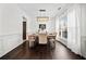 Bright dining room featuring hardwood floors, decorative wainscoting, and a modern rectangular light fixture at 113 Plumeria St, Canton, GA 30114