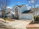 A beautifully landscaped house featuring an attached garage, a long driveway, and manicured landscaping at 113 Plumeria St, Canton, GA 30114