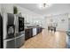 Well-lit kitchen features stainless steel appliances, dark cabinets, and breakfast nook at 113 Plumeria St, Canton, GA 30114